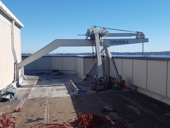 davit crane on spencer building being installed