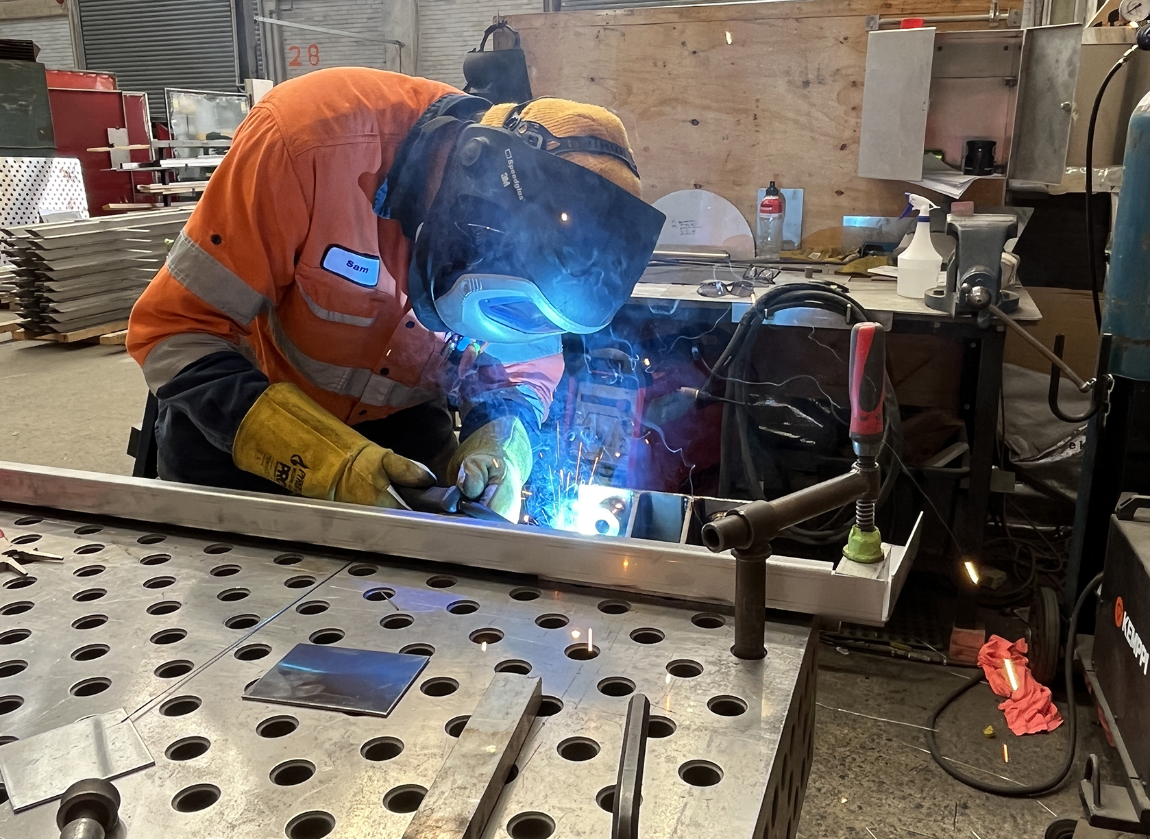 Sheetmetal welder working on train parts