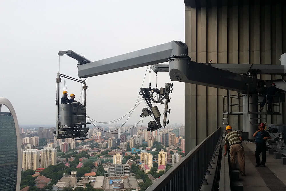 BMU cages on TVCC Beijing BMU arm reaching and bending tile