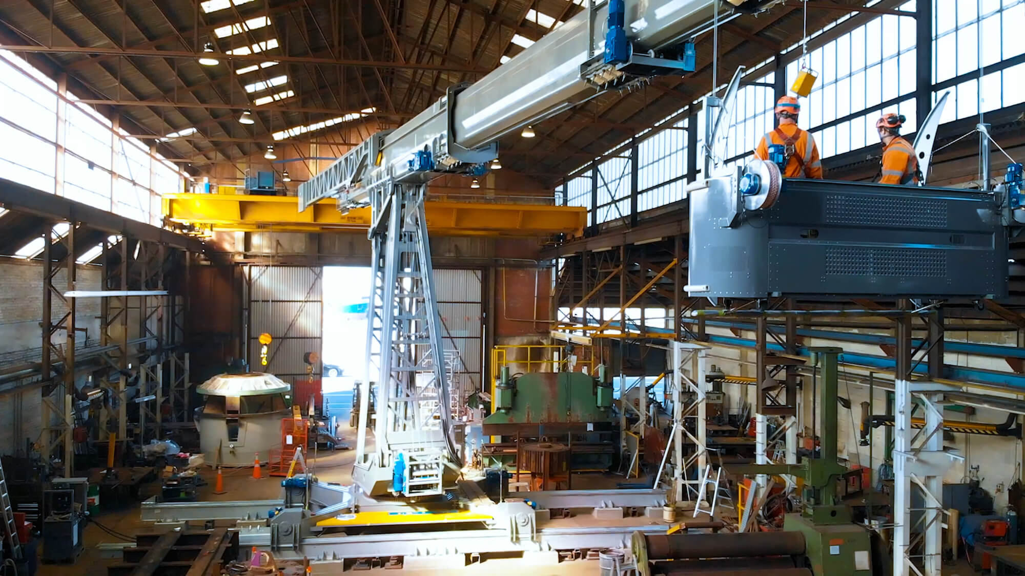 engineers riding in bmu cage in workshop while testing v2