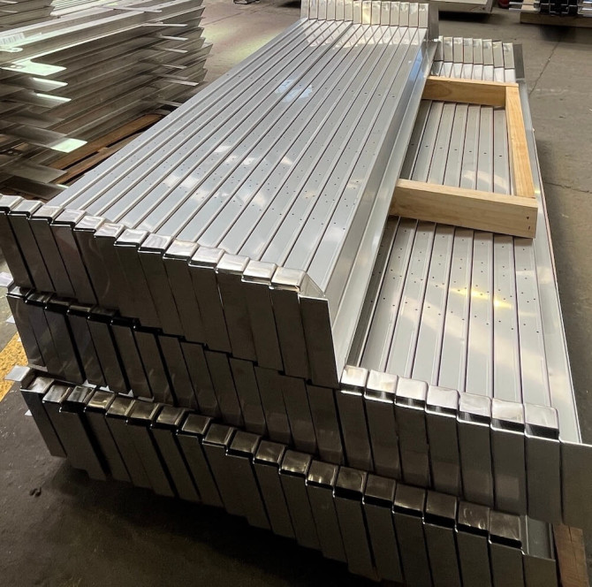 stainless train parts stacked in workshop